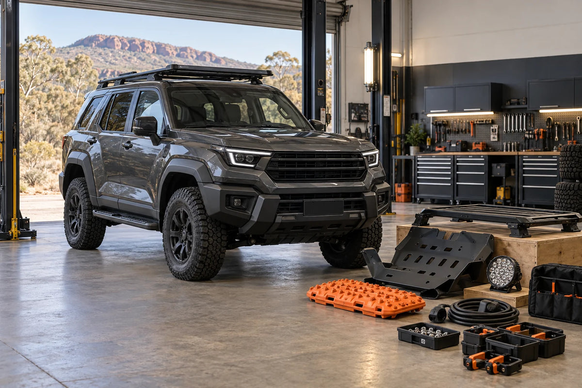 AI editorial concept of a boxy premium 4WD in an Australian accessory workshop with roof, protection, recovery and electrical parts prepared for fitment checks