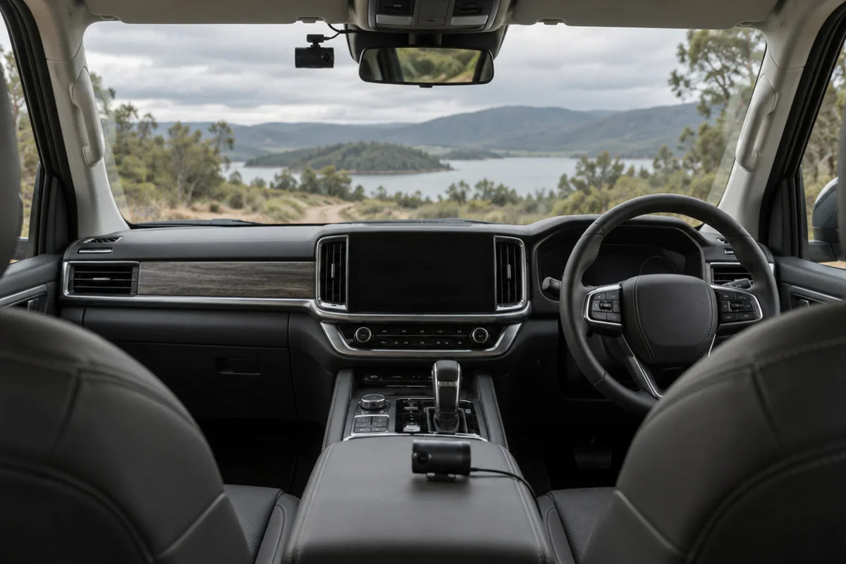 Generic AI editorial concept of a right-hand-drive SUV cabin with two dash-camera options; not a GWM TANK 500 fitment photograph
