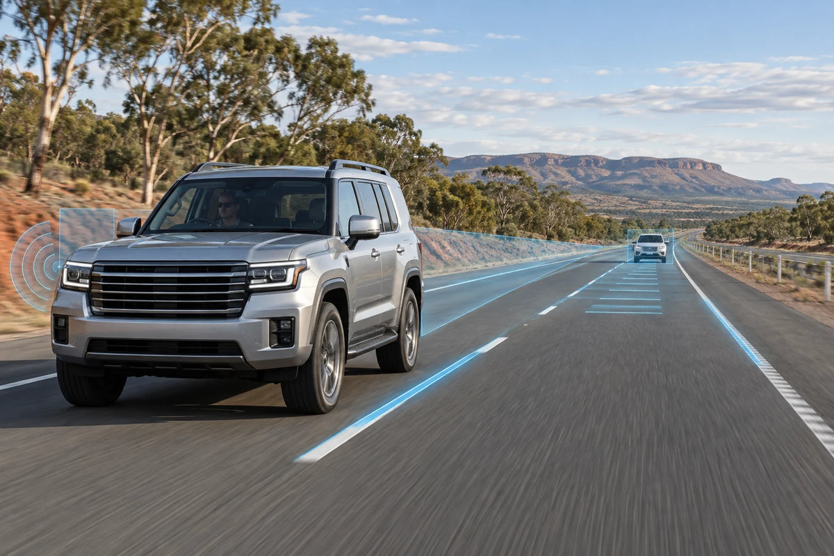 AI editorial concept of a large silver 4WD on an Australian highway with subtle lane, radar and blind-spot driver-assistance visualisations