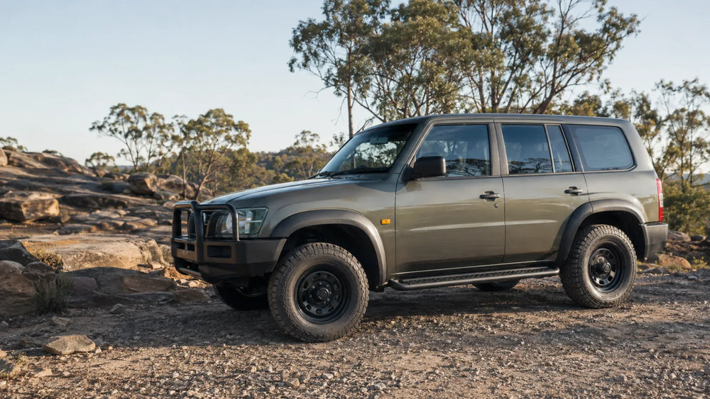 Boxy 4WD fitted with side steps at a rocky Australian trailhead