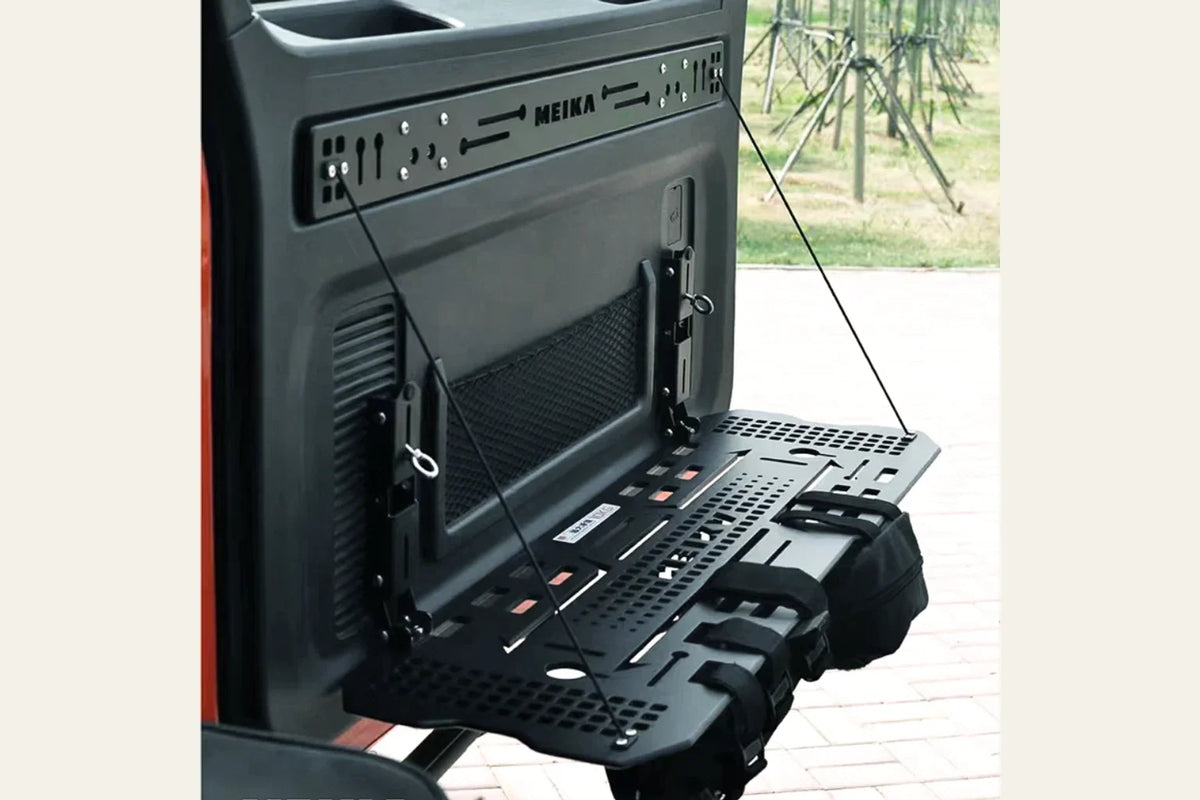 MK TANK 300 tail-door table product photograph showing its deployed perforated surface, support cables and mounting rail